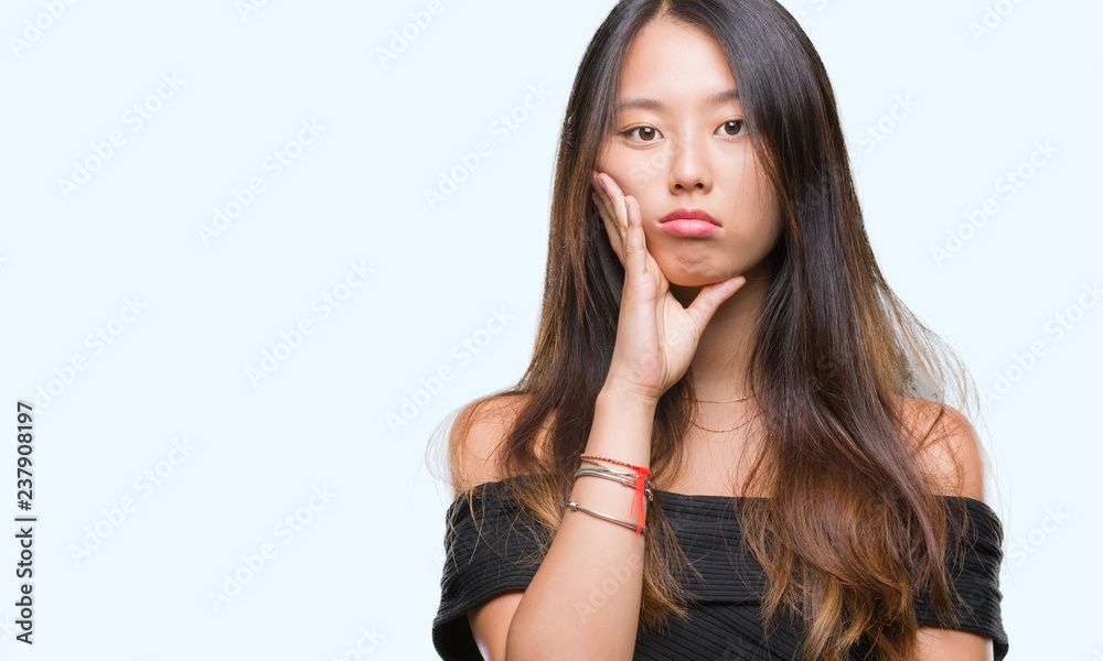 Young asian woman over isolated background thinking looking tired and bored with depression problems with crossed arms. Young asian woman over isolated background thinking looking tired and bored with depression problems with crossed arms.