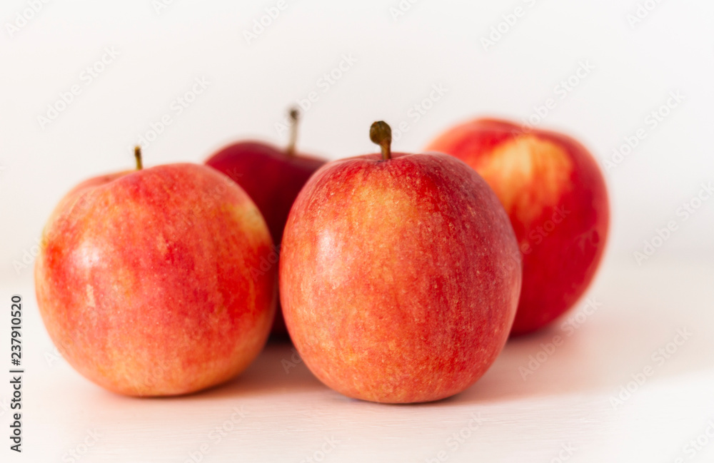 Ripe red apples on a table on a white background Ripe red apples on a table on a white background