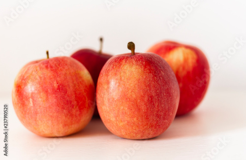 Ripe red apples on a table on a white background