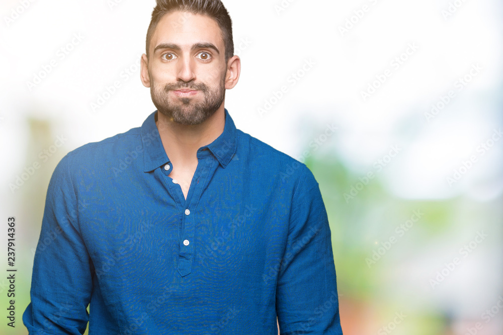 Young handsome man over isolated background puffing cheeks with funny face. Mouth inflated with air, crazy expression. Young handsome man over isolated background puffing cheeks with funny face. Mouth inflated with air, crazy expression.