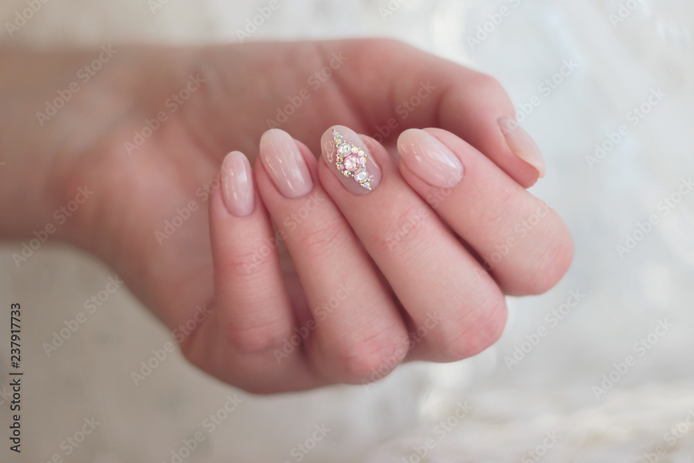 gentle pink manicure with rhinestones on the middle finger gentle pink manicure with rhinestones on the middle finger