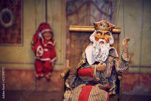 Handmade wooden puppet theater. King and Jester. Selective focus © Petr Bonek