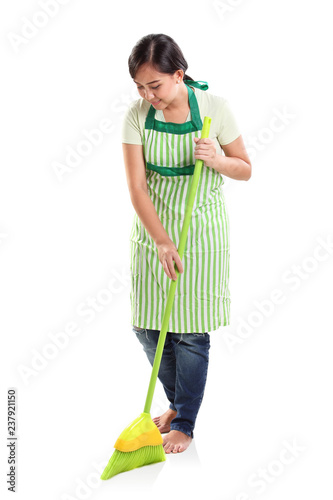Cleaning lady sweeping the floor, studio portrait