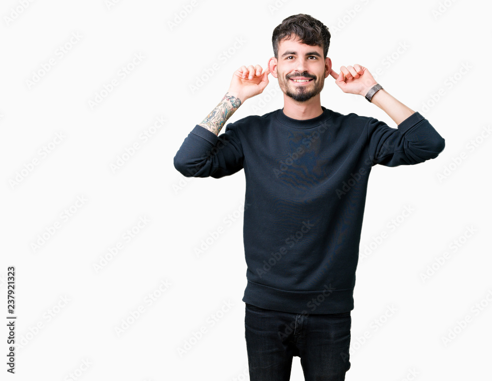 Young handsome man over isolated background Smiling pulling ears with fingers, funny gesture. Audition problem Young handsome man over isolated background Smiling pulling ears with fingers, funny gesture. Audition problem