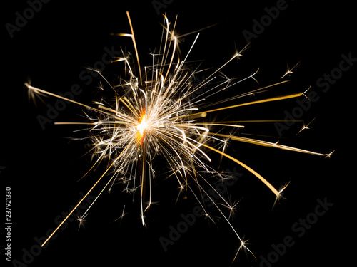 The Bengal fire burns . Sparks from the Bengal fire on a black isolated background. To insert an image in overlay mode