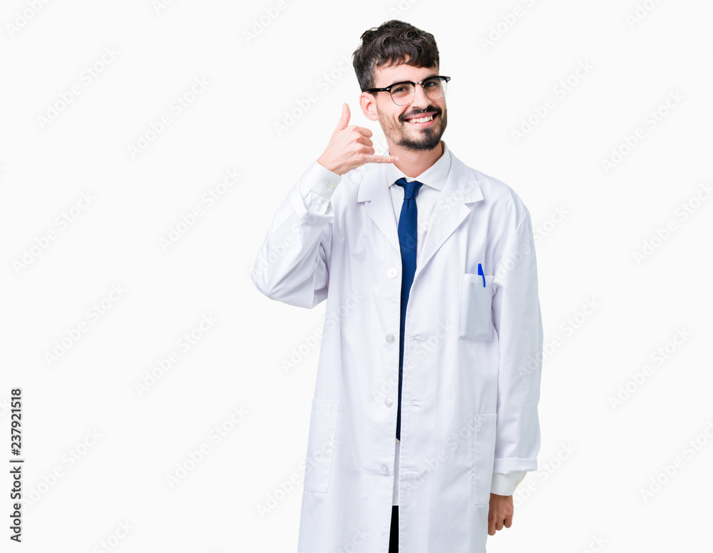 Young professional scientist man wearing white coat over isolated background smiling doing phone gesture with hand and fingers like talking on the telephone. Communicating concepts. Young professional scientist man wearing white coat over isolated background smiling doing phone gesture with hand and fingers like talking on the telephone. Communicating concepts.
