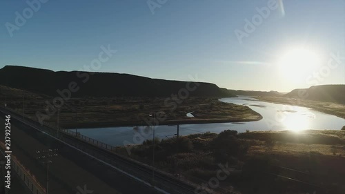 Dolly Slide Revealing Arched Bridge over River at Sunrise