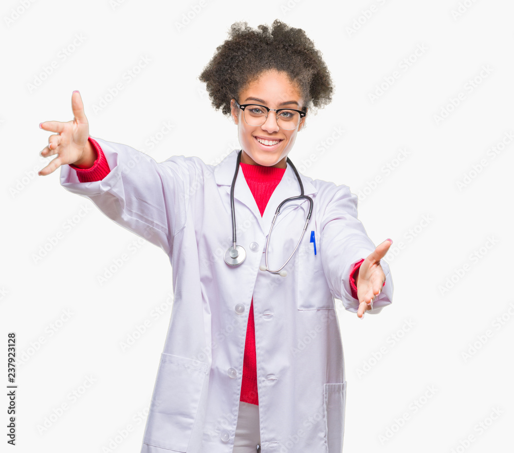 Young afro american doctor woman over isolated background looking at the camera smiling with open arms for hug. Cheerful expression embracing happiness. Young afro american doctor woman over isolated background looking at the camera smiling with open arms for hug. Cheerful expression embracing happiness.