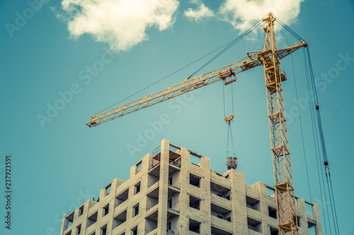 Construction crane and building against blue sky
