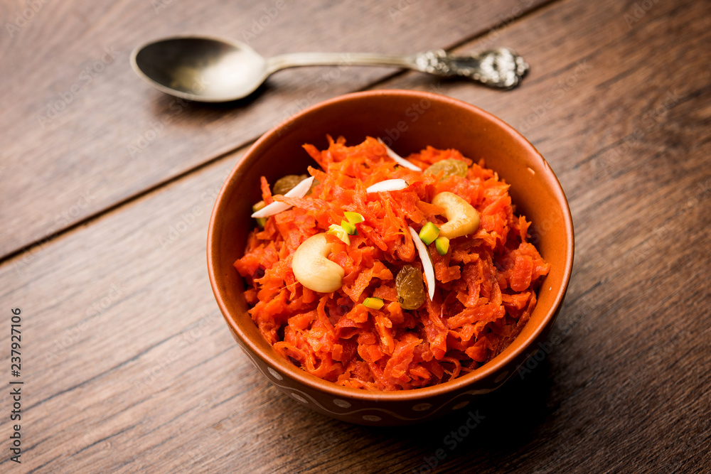 Gajar ka halwa is a carrot-based sweet dessert pudding from India. Garnished with Cashew/almond nuts. served in a bowl. Gajar ka halwa is a carrot-based sweet dessert pudding from India. Garnished with Cashew/almond nuts. served in a bowl.