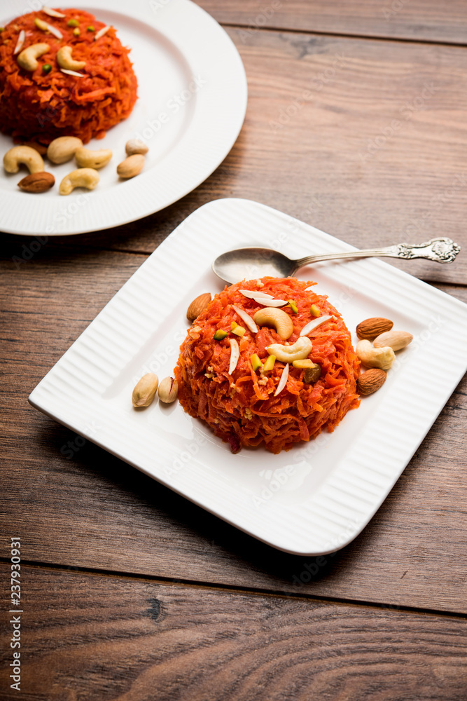 Gajar ka halwa is a carrot-based sweet dessert pudding from India. Garnished with Cashew/almond nuts. served in a bowl. Gajar ka halwa is a carrot-based sweet dessert pudding from India. Garnished with Cashew/almond nuts. served in a bowl.