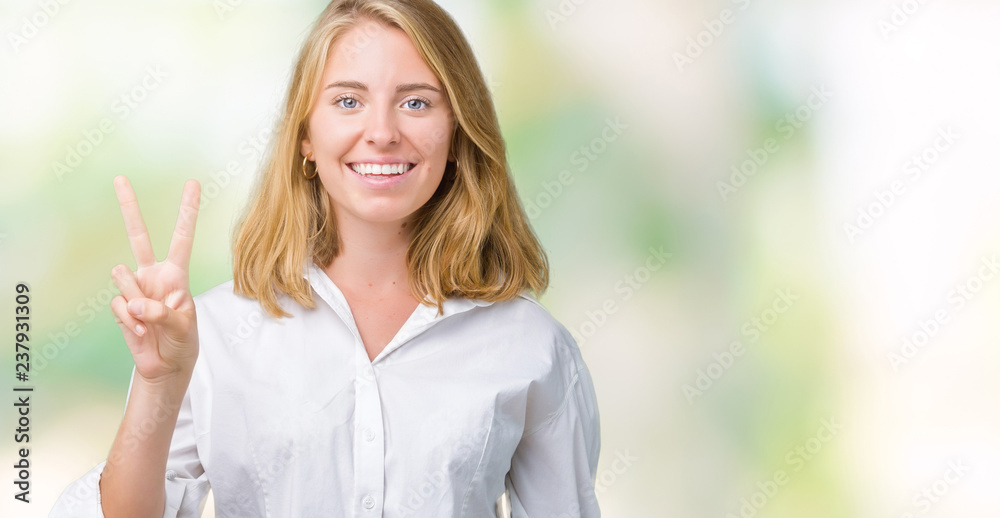 Fototapeta premium Beautiful young business woman over isolated background showing and pointing up with fingers number two while smiling confident and happy.