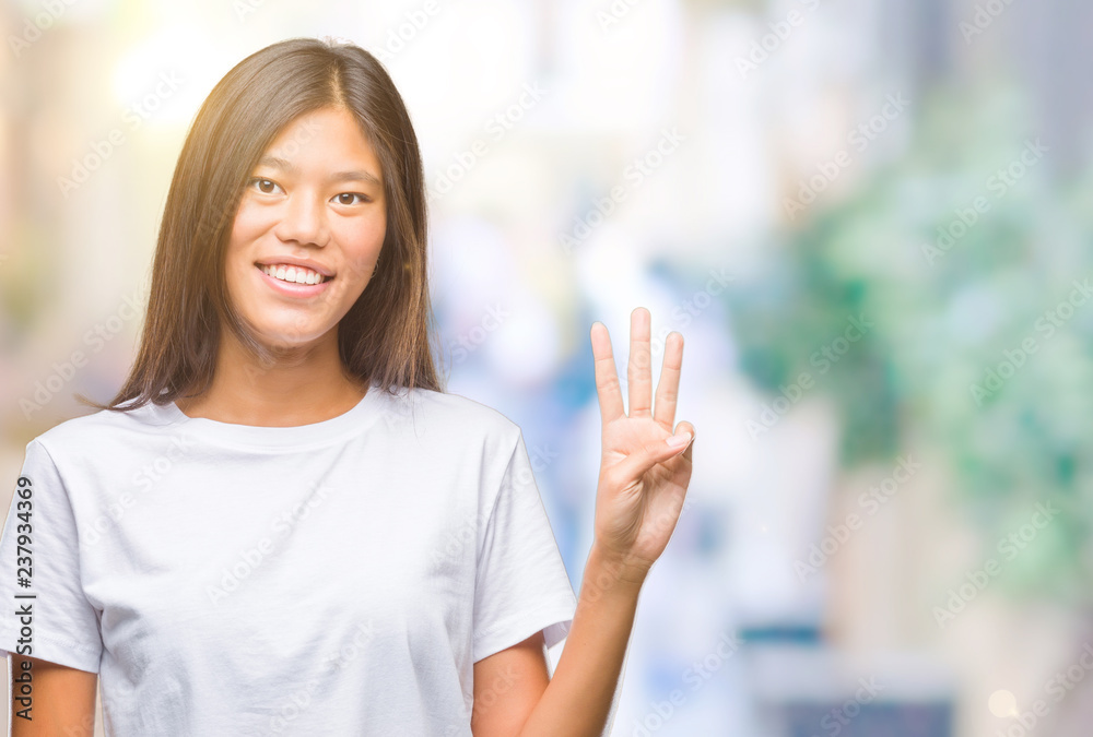 Young asian woman over isolated background showing and pointing up with fingers number three while smiling confident and happy. Young asian woman over isolated background showing and pointing up with fingers number three while smiling confident and happy.