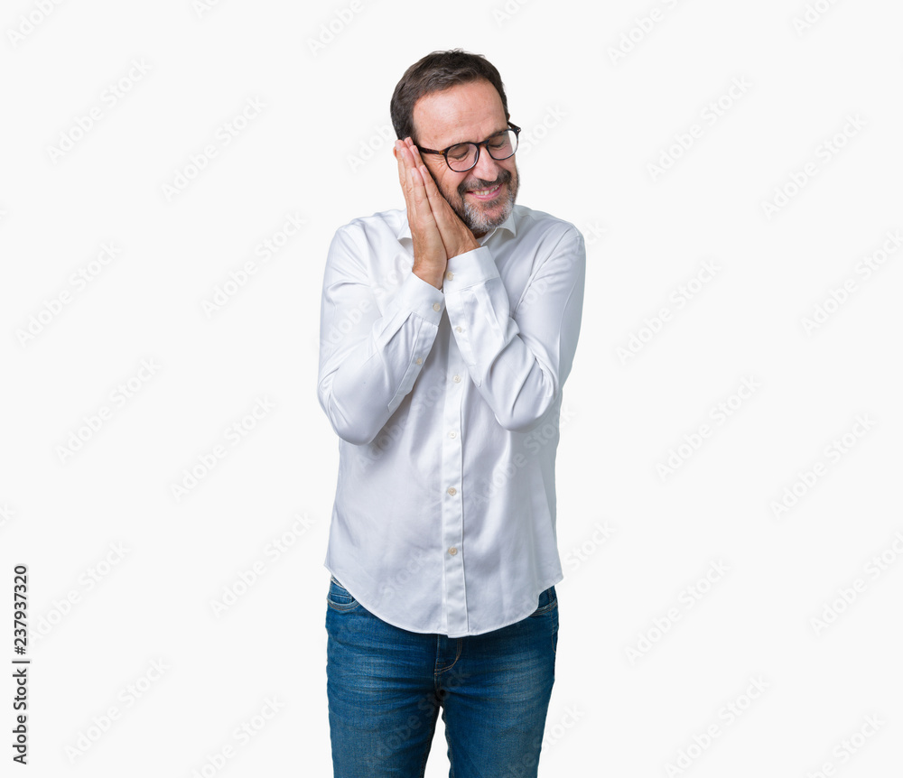 Handsome middle age elegant senior business man wearing glasses over isolated background sleeping tired dreaming and posing with hands together while smiling with closed eyes. Handsome middle age elegant senior business man wearing glasses over isolated background sleeping tired dreaming and posing with hands together while smiling with closed eyes.