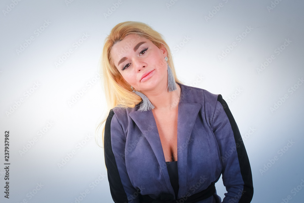 Head tilted to the right. A girl in a gray suit looks into the camera at the hospital. Head tilted to the right. A girl in a gray suit looks into the camera at the hospital.