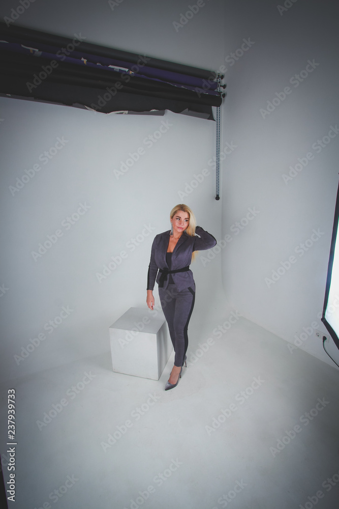 White to light blue gradient background. Girl in full growth shooting in the studio white cube. White to light blue gradient background. Girl in full growth shooting in the studio white cube.