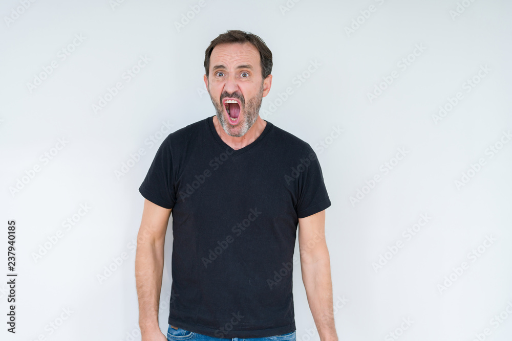 Obraz premium Senior man over isolated background In shock face, looking skeptical and sarcastic, surprised with open mouth