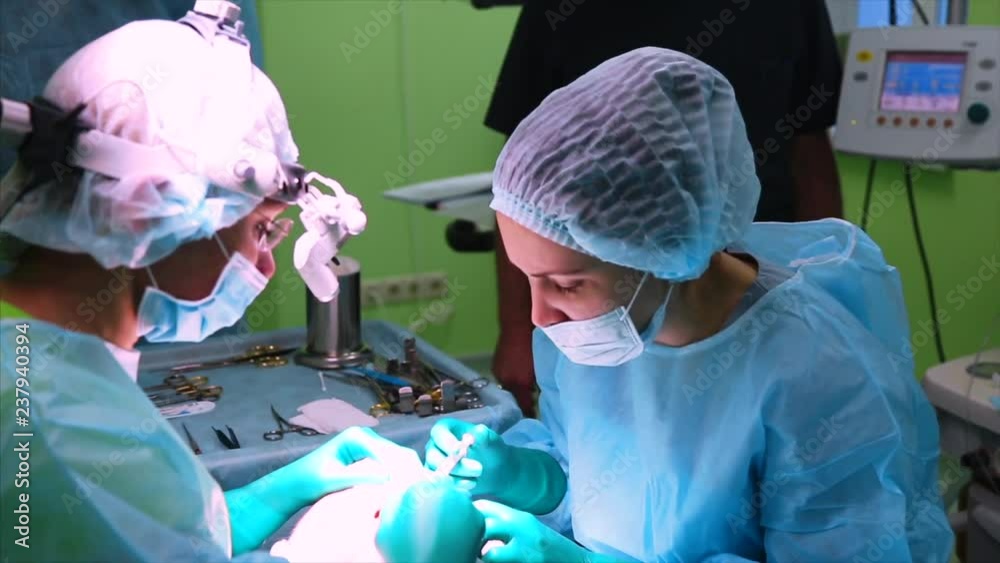 OpThe surgeon is performing an operation on the eyes, close-up. Correction of. The doctor does blepharoplasty. Operation in the operating room.eration BREST OpThe surgeon is performing an operation on the eyes, close-up. Correction of. The doctor does blepharoplasty. Operation in the operating room.eration BREST