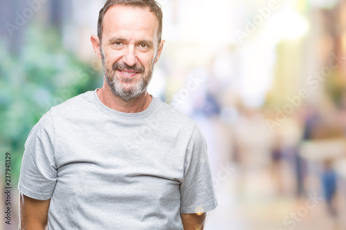 Middle age senior hoary man over isolated background with serious expression on face. Simple and natural looking at the camera.