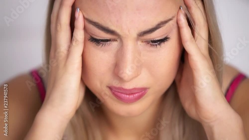 Wallpaper Mural A girl’s headache, a woman has headache in different life circumstances, she clearly shows that she is in pain, clutches her head, a woman’s migraine, takes migraine pills, works on camera Torontodigital.ca