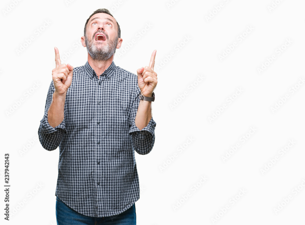 Middle age hoary senior man over isolated background amazed and surprised looking up and pointing with fingers and raised arms. Middle age hoary senior man over isolated background amazed and surprised looking up and pointing with fingers and raised arms.