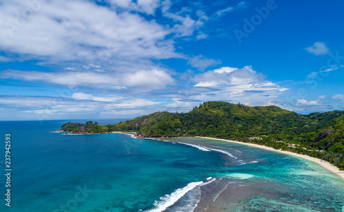 Tropical beach with sea and palm taken from drone. Beach and sea photo. Romantic beach aerial view.