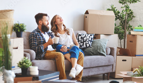 happy young married couple moves to new apartment photo