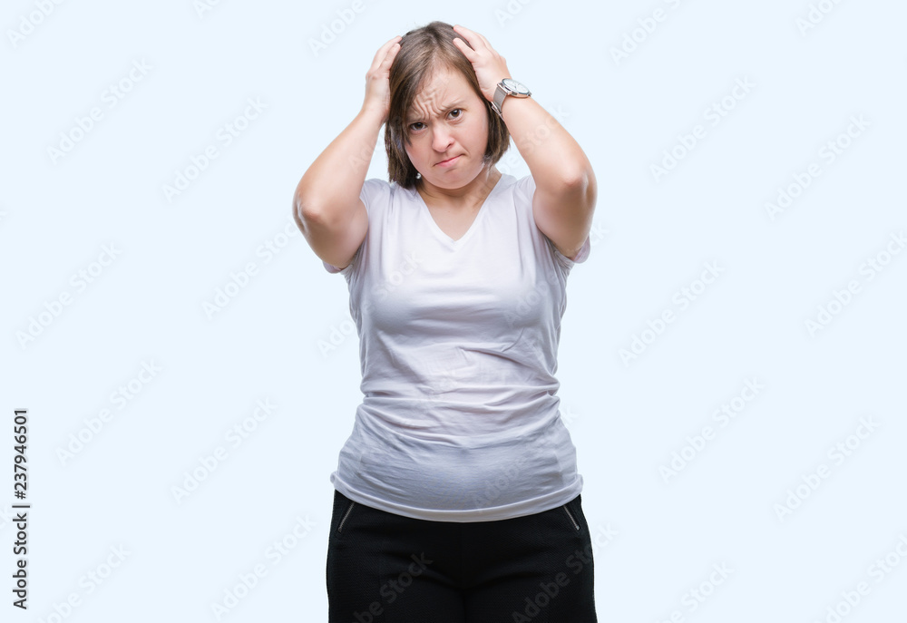 Young adult woman with down syndrome over isolated background suffering from headache desperate and stressed because pain and migraine. Hands on head. Young adult woman with down syndrome over isolated background suffering from headache desperate and stressed because pain and migraine. Hands on head.