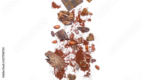 Chocolate bar, cocoa beans, pieces on a white isolated background. Top view. Copy space.  