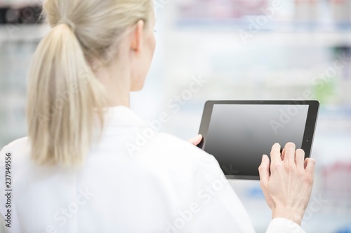Pharmacist using digital tablet photo