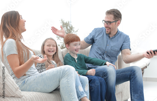 cheerful family sitting on the couch in the living room