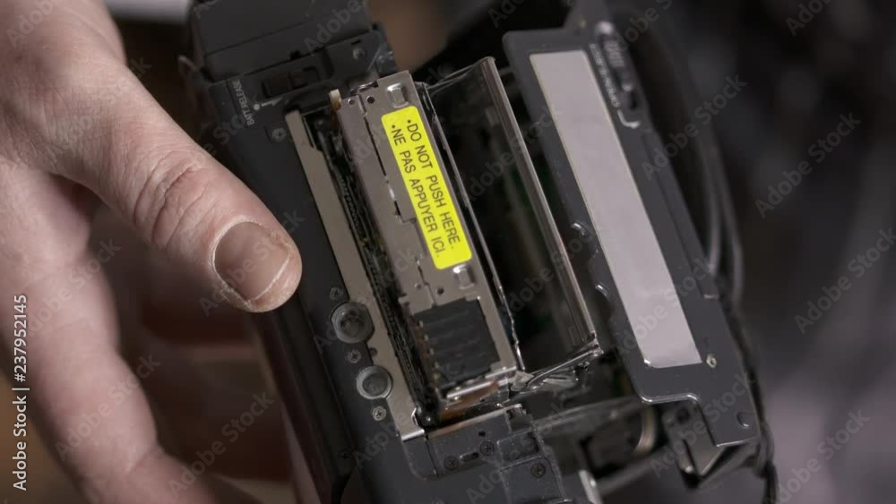 Inserting mini DV cassette tape into the camcorder Inserting mini DV cassette tape into the camcorder