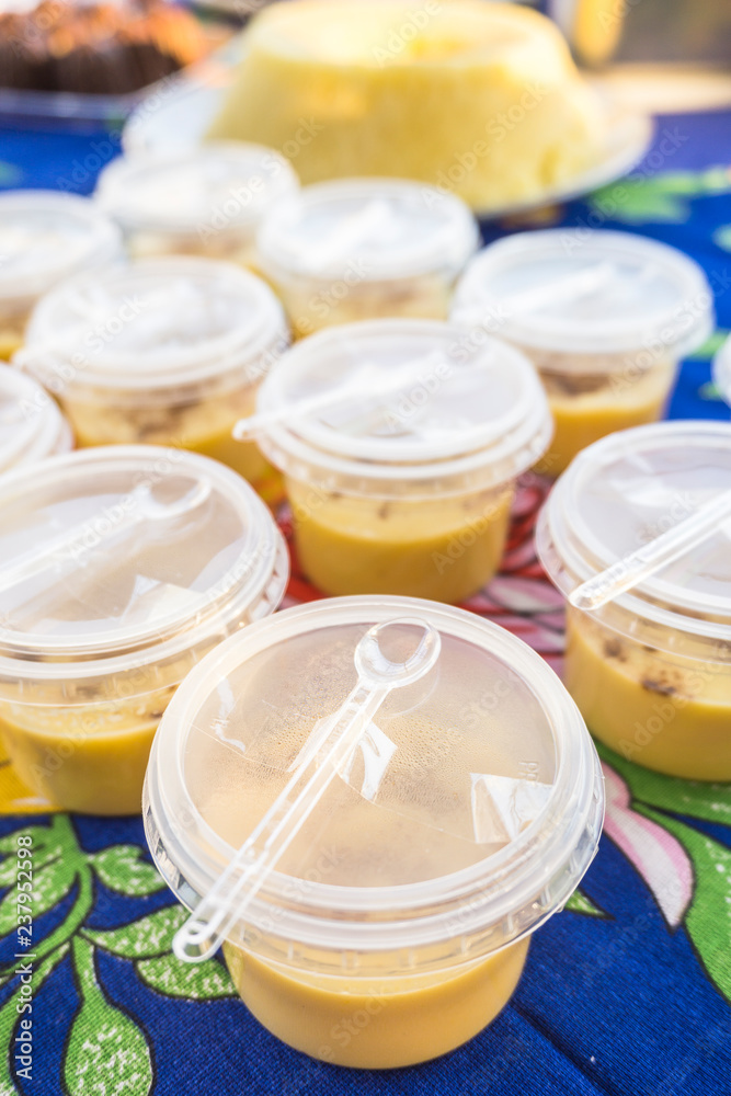 Brazilian Curau with cinnamon in plastic cups Brazilian Curau with cinnamon in plastic cups