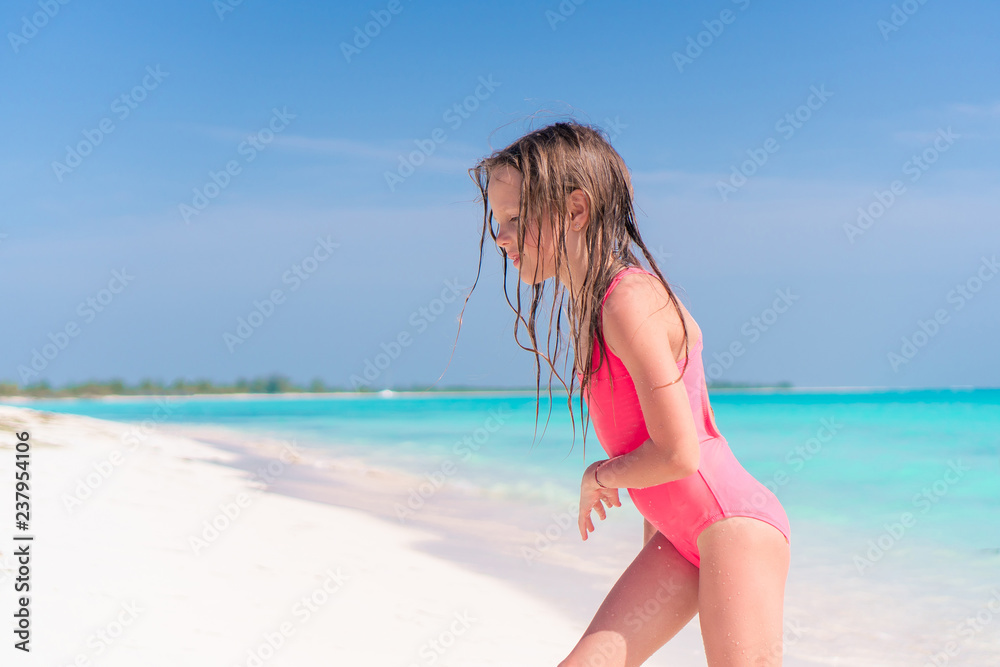 Portrait of adorable little girl at beach on her summer vacation