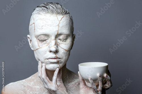 portrait of a woman holding white cup isolated over white