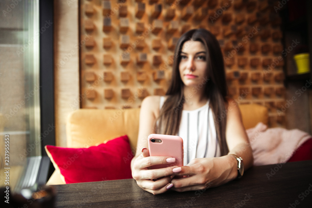 Young pretty woman blogger in cafe in city centre with smartphone Young pretty woman blogger in cafe in city centre with smartphone