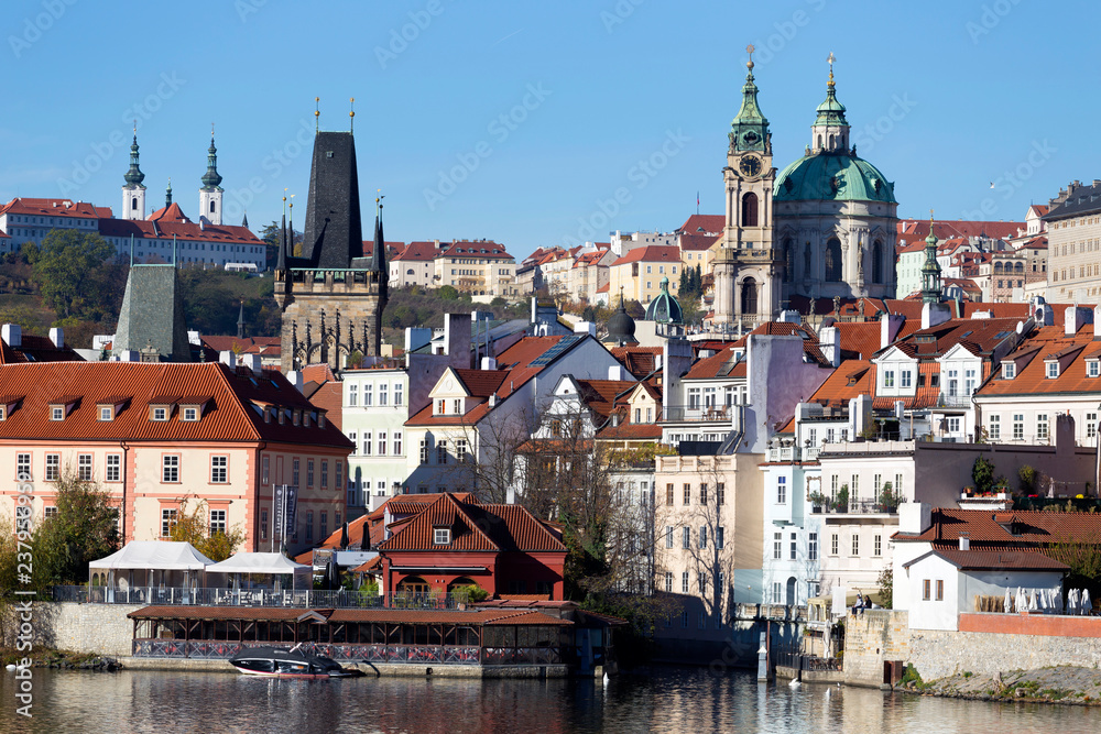  Colorful autumn Prague St. Nicholas' Cathedral with the Lesser Town above River Vltava in the sunny Day, Czech Republic