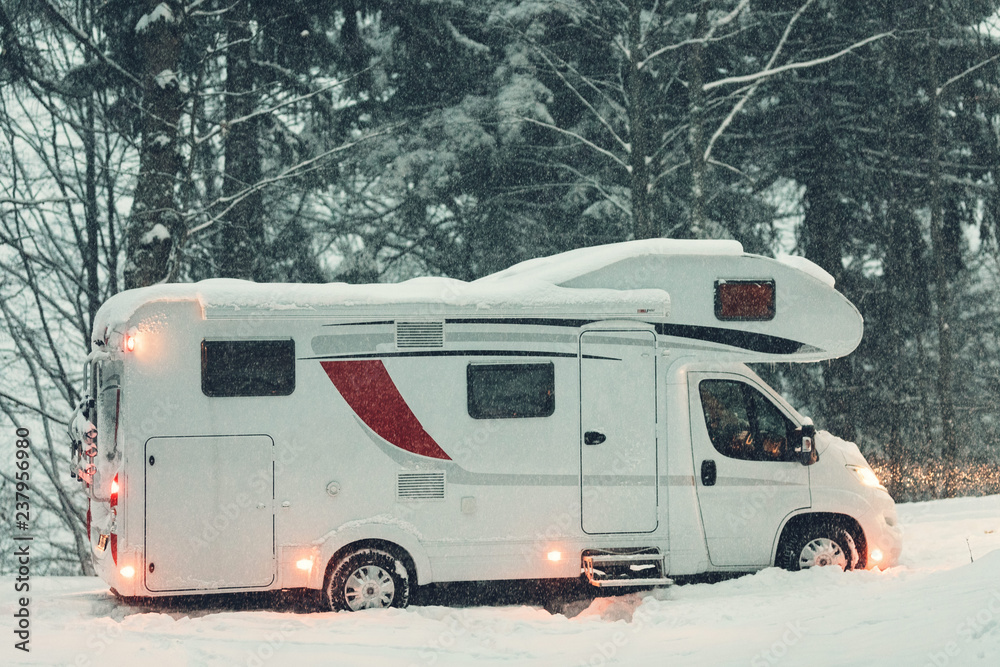 campervan caravan vehicle for van life holiday on camper van journey camping in mountains near the forest in the winter adventure season. snowing on the camper outdoor nomad lifestyle campervan caravan vehicle for van life holiday on camper van journey camping in mountains near the forest in the winter adventure season. snowing on the camper outdoor nomad lifestyle
