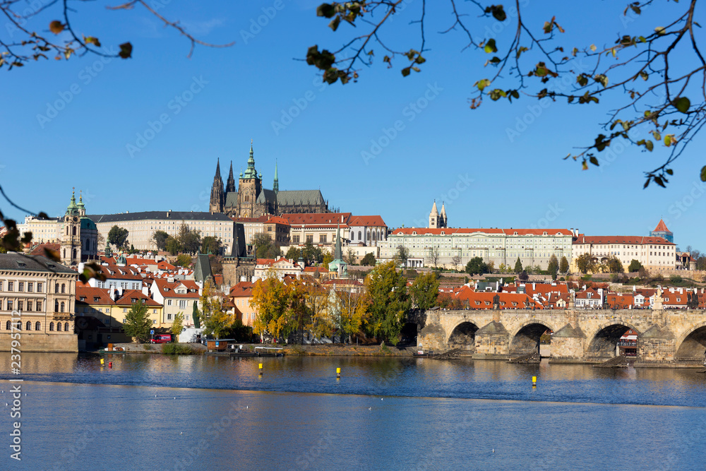 Obraz premium Colorful autumn Prague gothic Castle and Charles Bridge with the Lesser Town in the sunny Day, Czech Republic