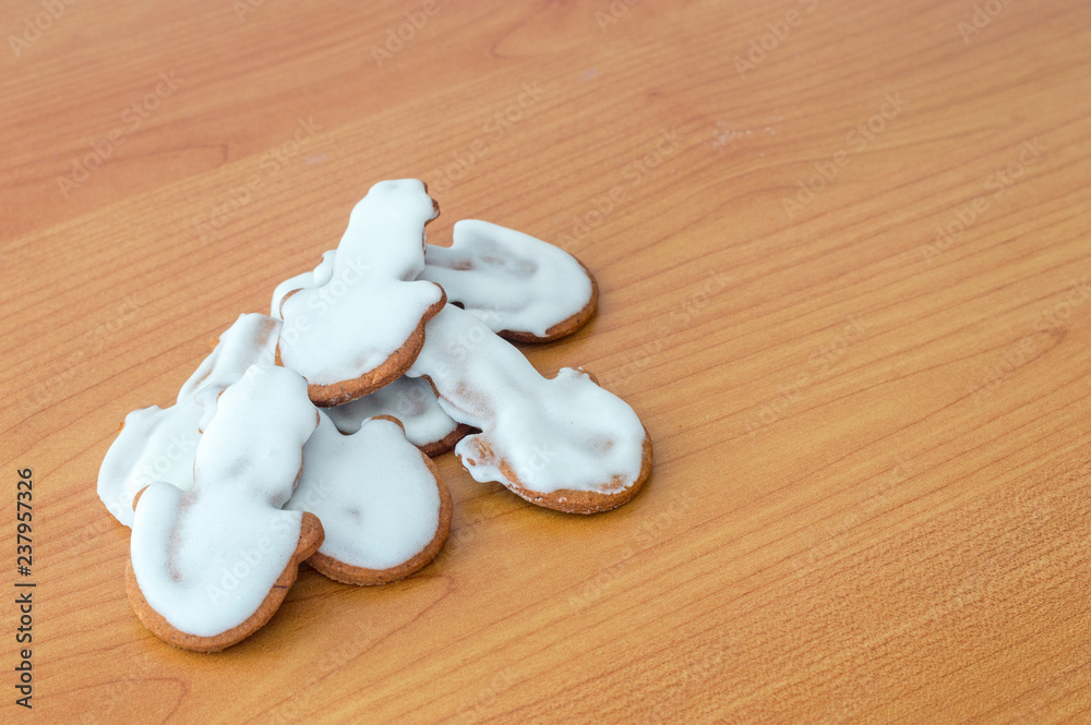 Fototapeta premium Snowman gingerbread cakes with icing for Christmas on wooden table.