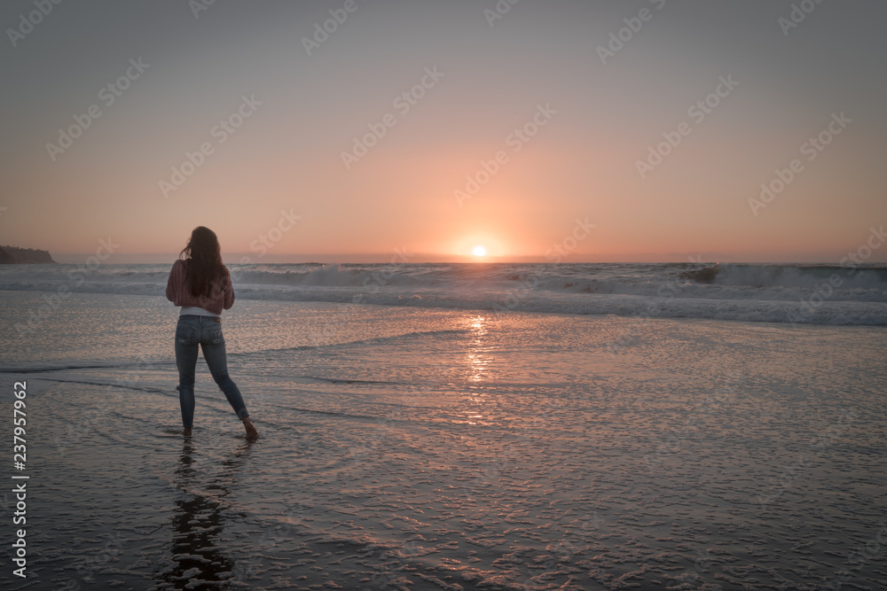 Women watching the beautiful sunset over the Pacific Ocean.  Redondo Beach just outside Los Angeles. 