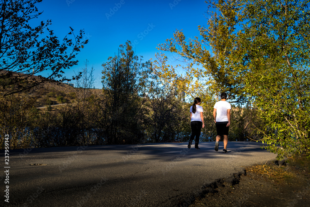 A young man and woman are walking in nature. Weekend activity of city people