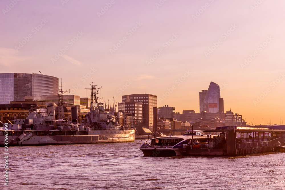 Beautiful sunset in London on the river Thames with buildings and boats