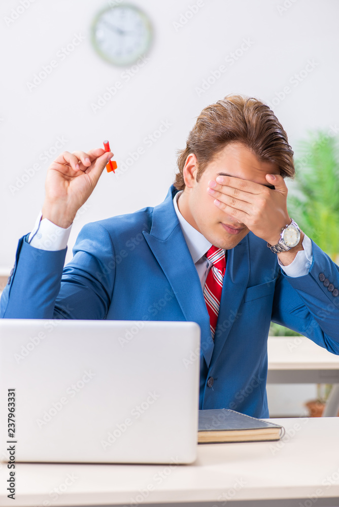 Businessman throwing dart in business concept Businessman throwing dart in business concept