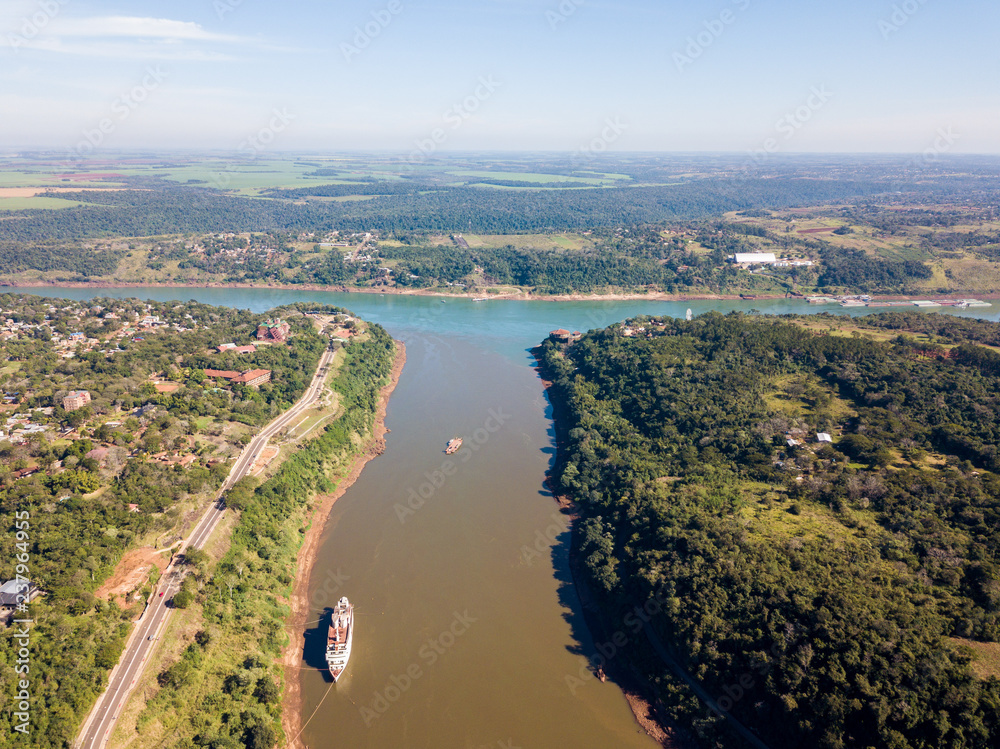 Triple Frontier, tri-border junction of Paraguay, Argentina and Brazil. Iguazú and Paraná rivers confluence. Aerial drone photo. Two color river