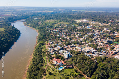 Town of Puerto Iguazu city centre aerial view. Tancredo Neves Bridge (Fraternity Bridge) border crossing Brazil—Argentina over the Iguassu River. photo