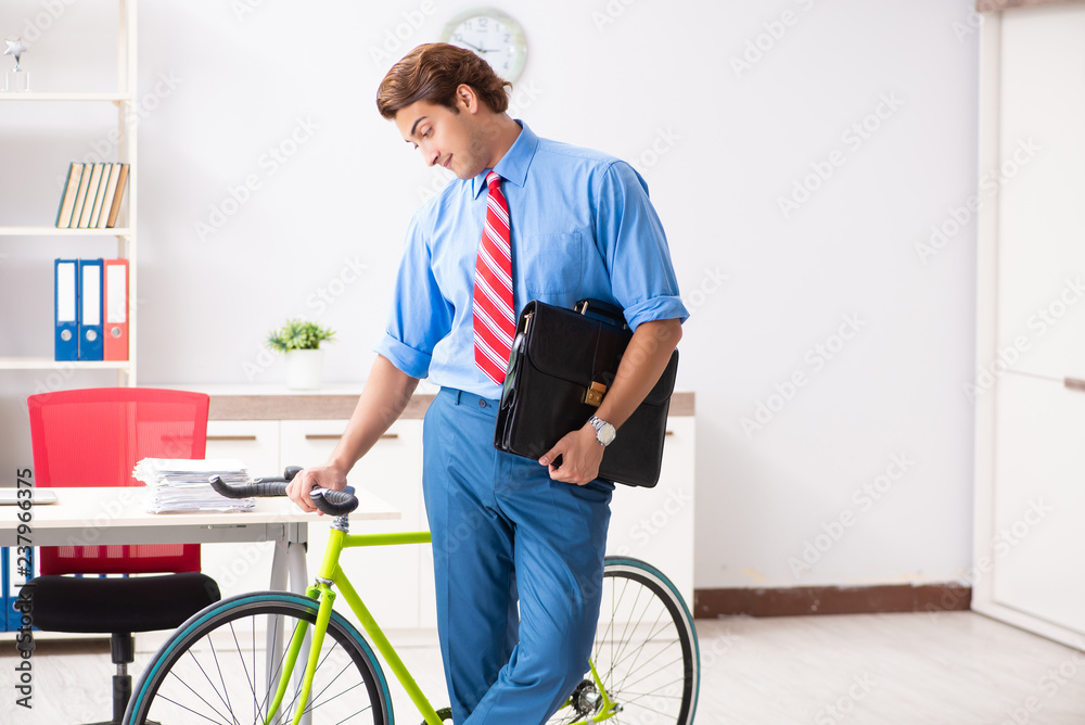 Young businessman using bike to commute to the office Young businessman using bike to commute to the office