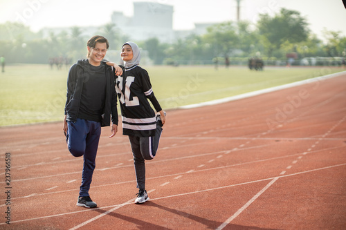 Asian couple at track stadium exercising for healthy lifestyle