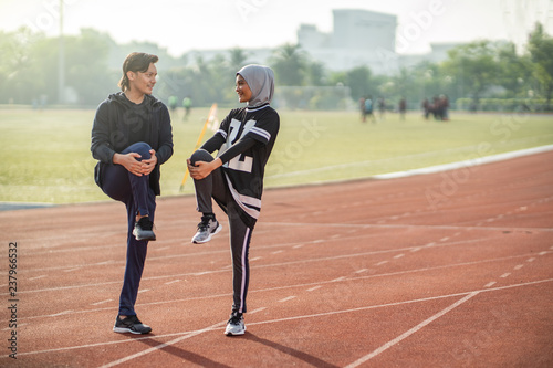 Fototapeta Naklejka Na Ścianę i Meble -  Asian couple at track stadium exercising for healthy lifestyle