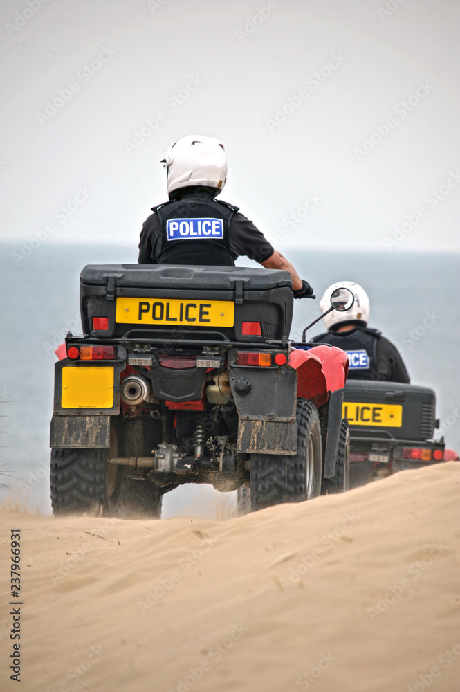 British Police on quads on the sand dunes of Formby, United Kingdom